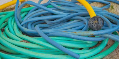 pile-multicolored-hoses-watering-garden-water-supply-selective-focus-plumbing-water-dispenser-equipment-reuse-materials-min